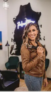 A woman holding a hair brush in her hand.