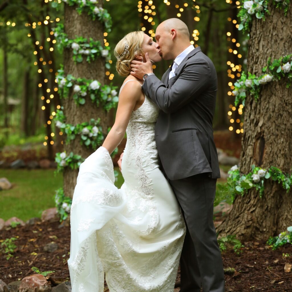 Wedding couple is kissing in a garden