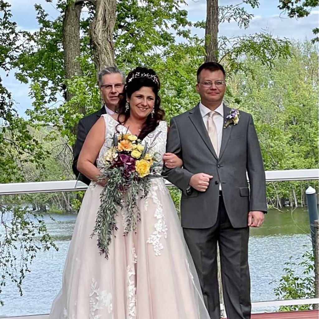 Wedding couple is giving pose with another man