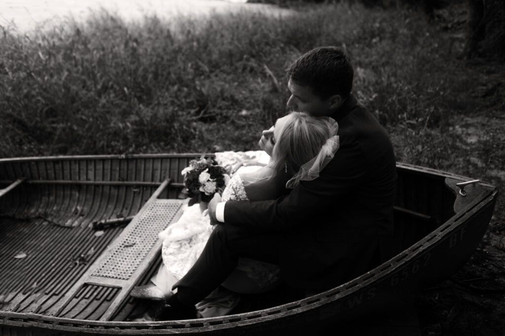 A man and child in a boat on the water.