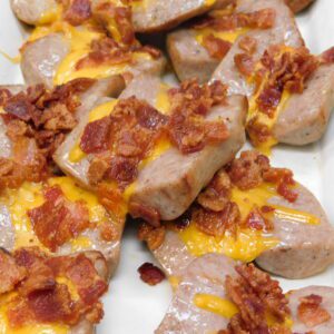 A plate of food with bacon and cheese.