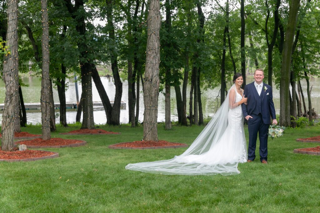 a bride and groom posing for a picture outdoor