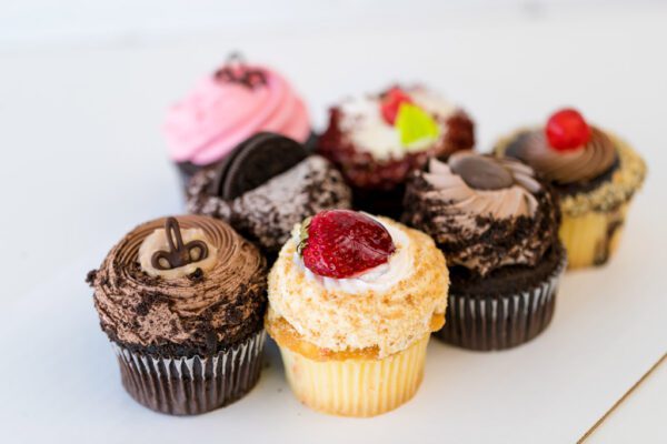 A close up of several different types of cupcakes.
