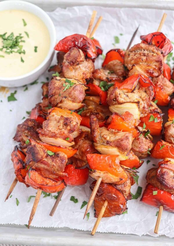 A close up of some kabobs on the grill