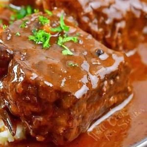 A close up of some meat covered in sauce