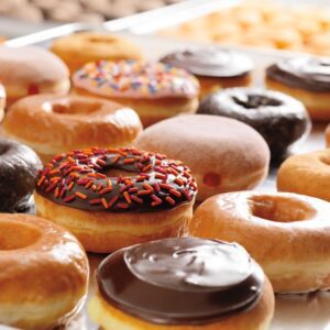 A bunch of different kinds of donuts on a table
