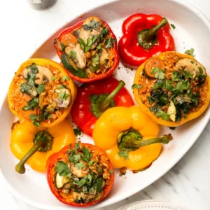 A plate of stuffed peppers with rice and vegetables.