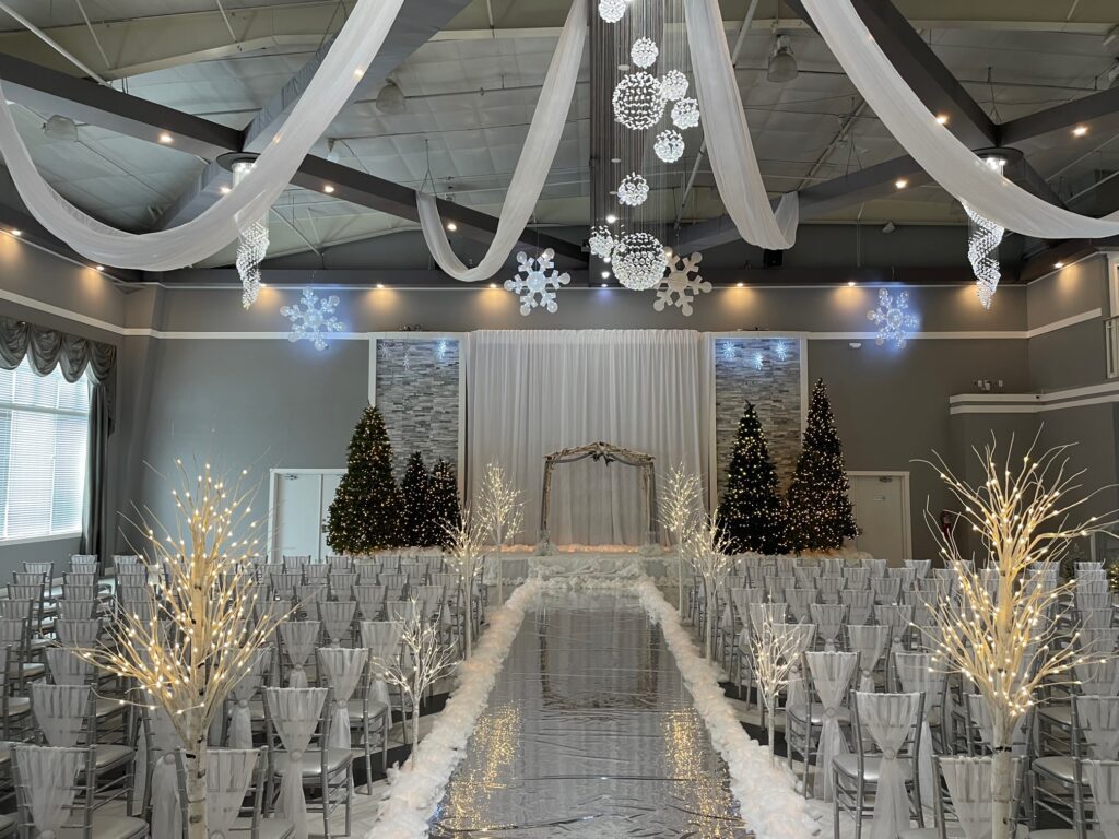 A large room with many white chairs and decorations