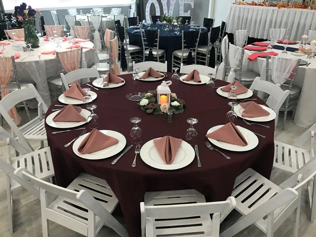 A round table with plates and napkins on it