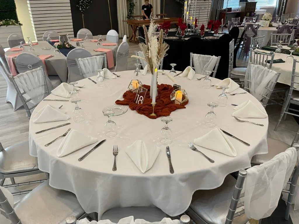 A table with silverware and wine glasses on it