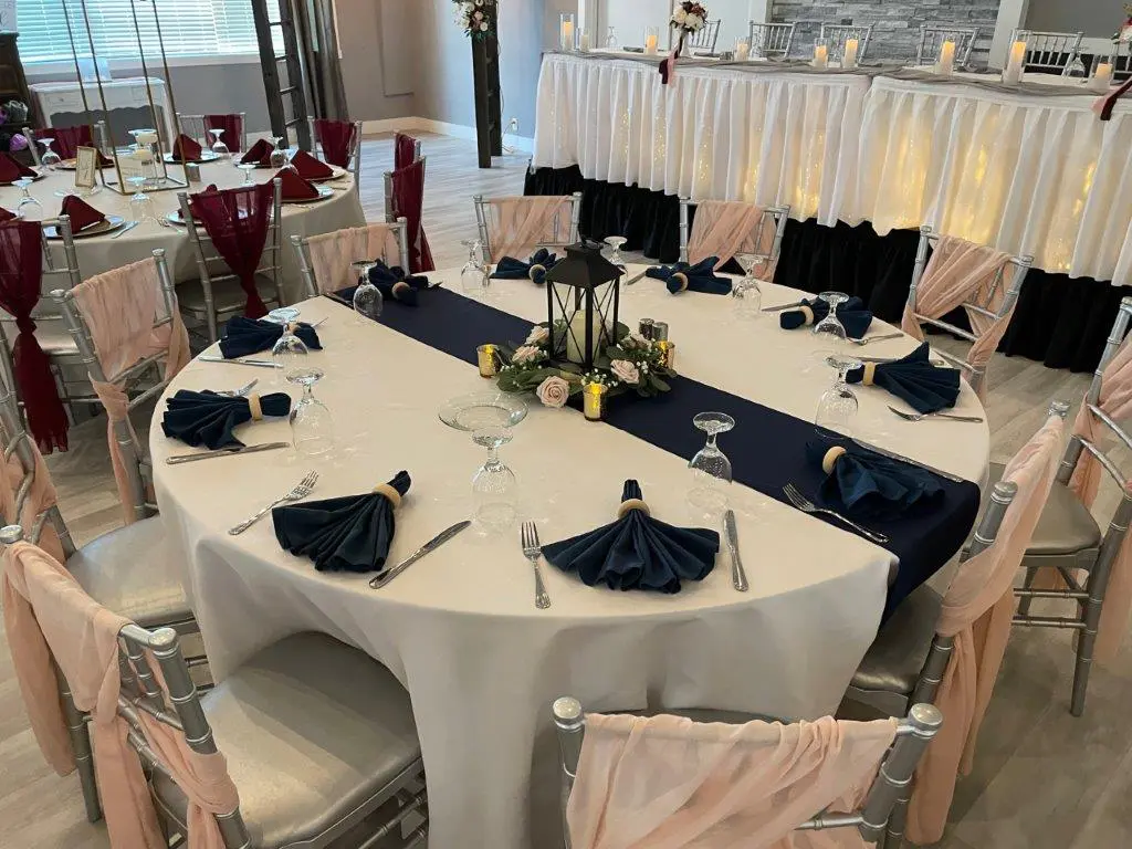 A table set up with white and blue linens.