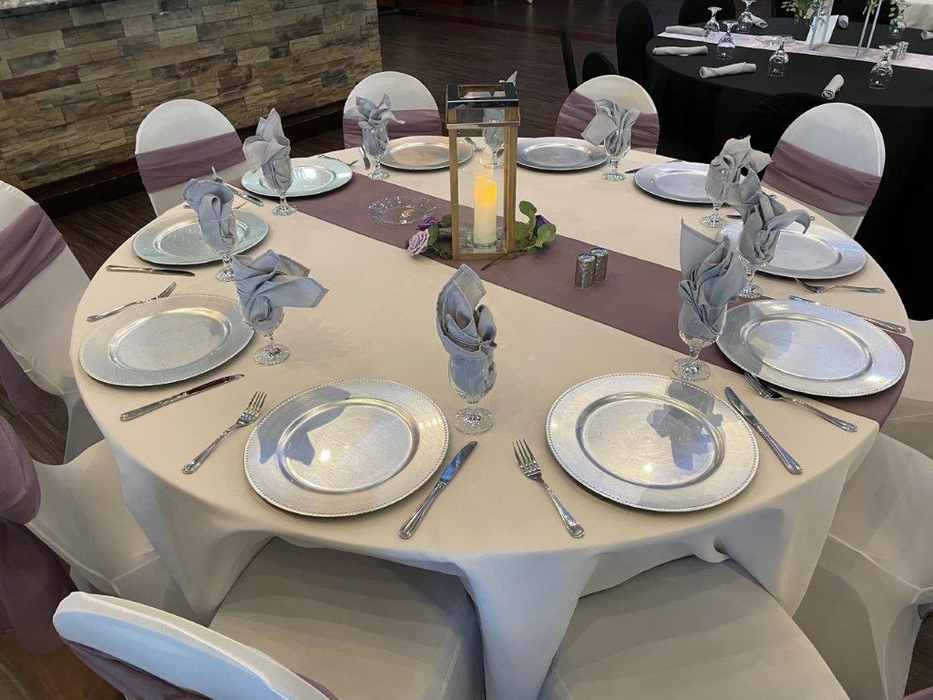 A table set with plates and silverware for dinner.