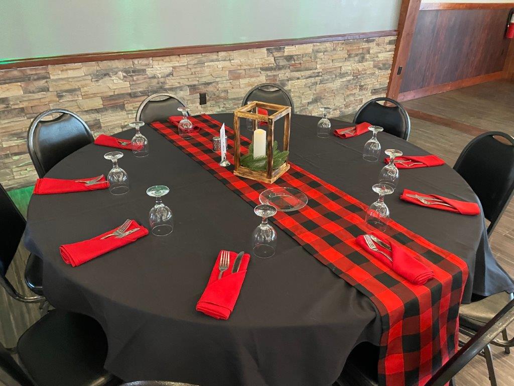 A table set with red and black plaid napkins.
