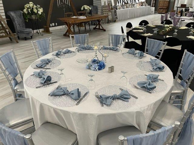 A table set with plates and silverware on top of it.