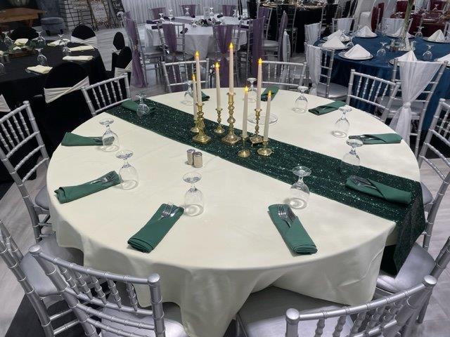 A table with candles and green napkins on it