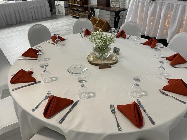 A table set with silverware and napkins on it.