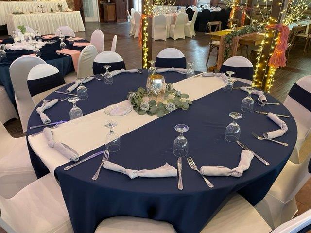 A table set up with blue and white linens.