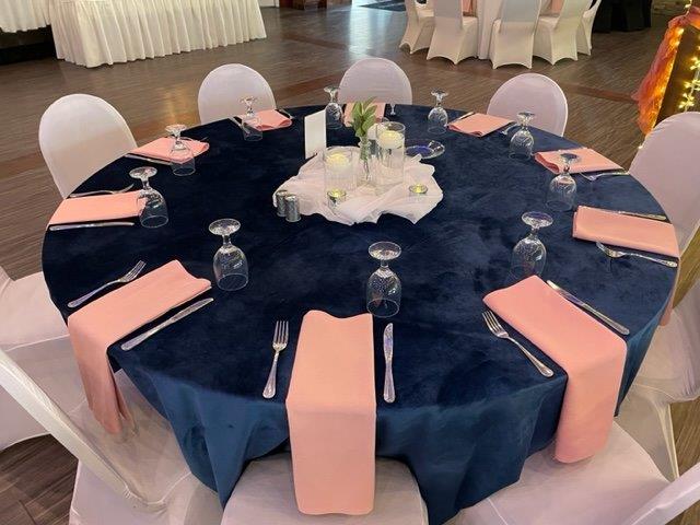 A table set up with pink and blue napkins.