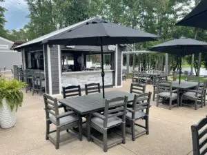 A patio with an umbrella and chairs outside