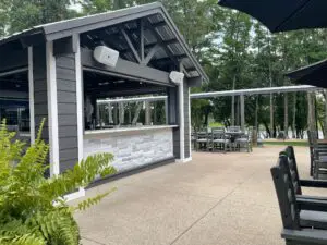 A large outdoor bar with tables and chairs.