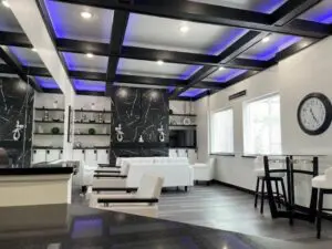 A room with white furniture and black walls.