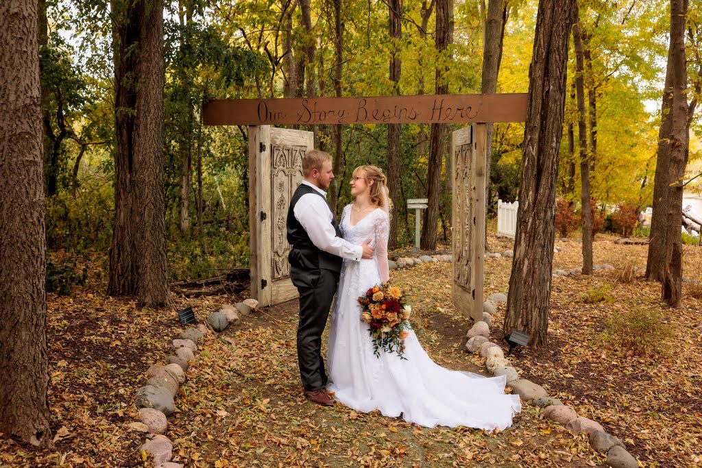 A bride and groom pose for their wedding picture.