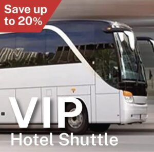 A white bus driving down the street with a sign that says " vip hotel shuttle ".